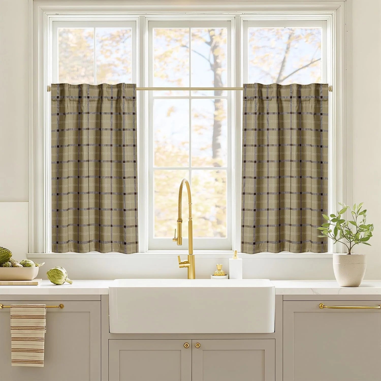 Beige plaid cafe curtains on a wide kitchen window above a farmhouse sink