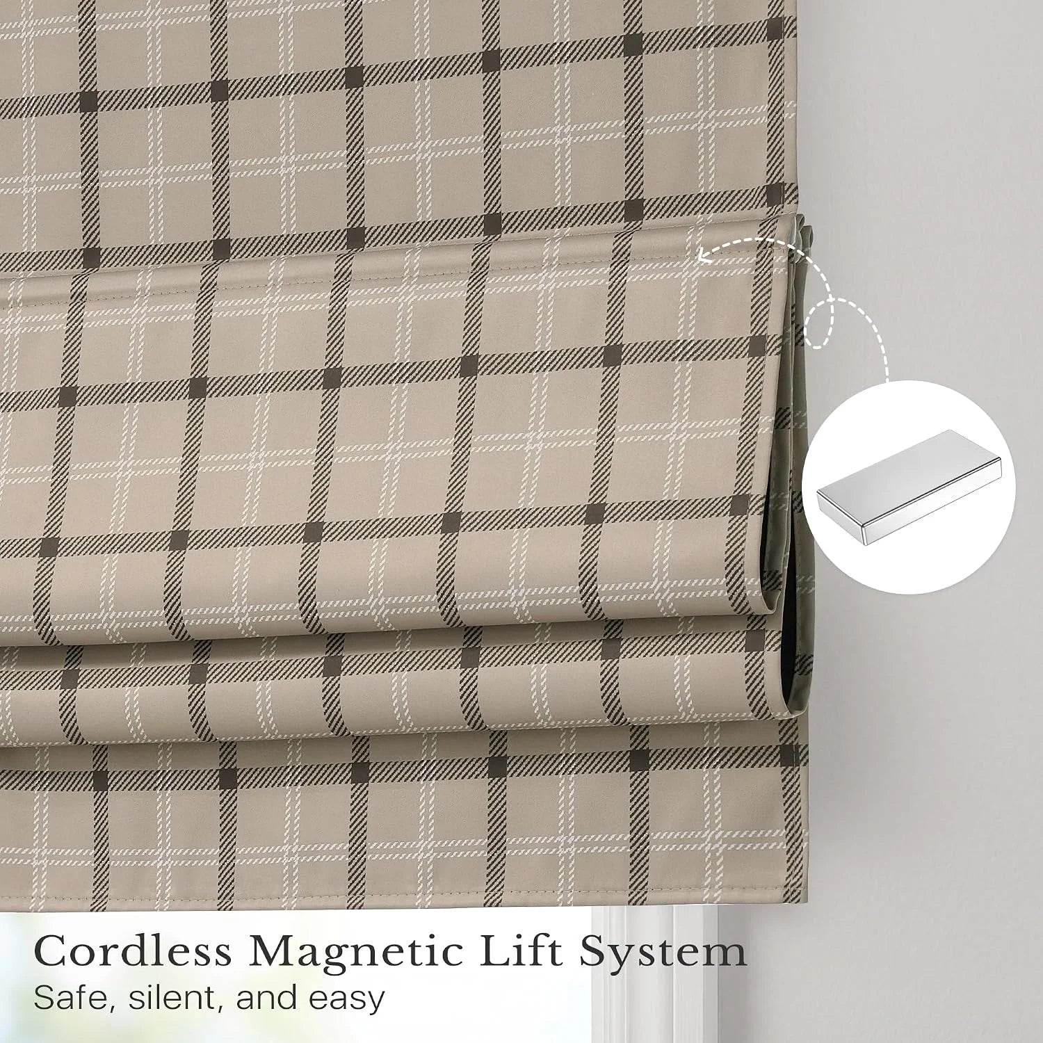 Beige plaid cordless Roman shade with magnetic lift system on a window