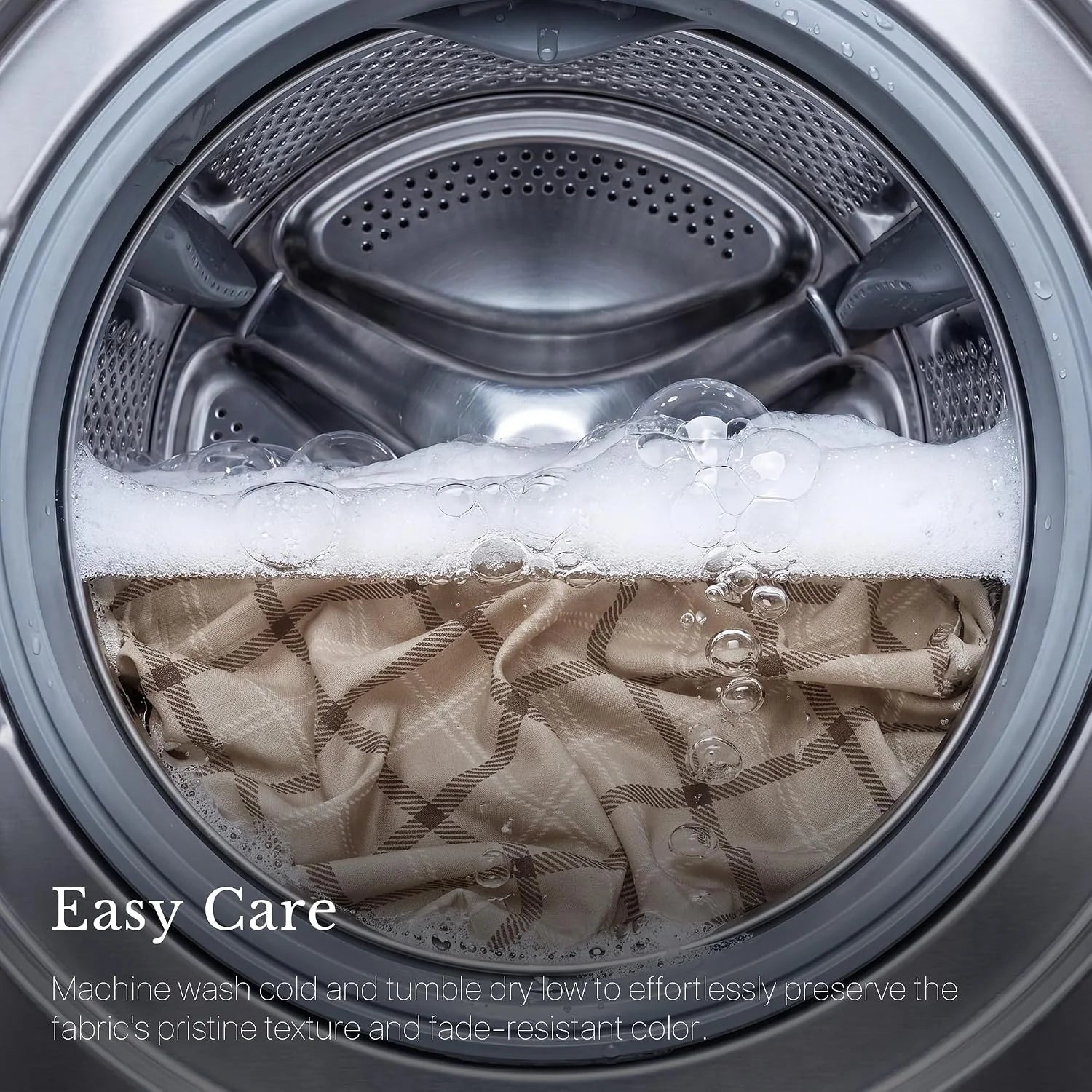 Beige plaid fabric washing in a front-load machine with soap bubbles