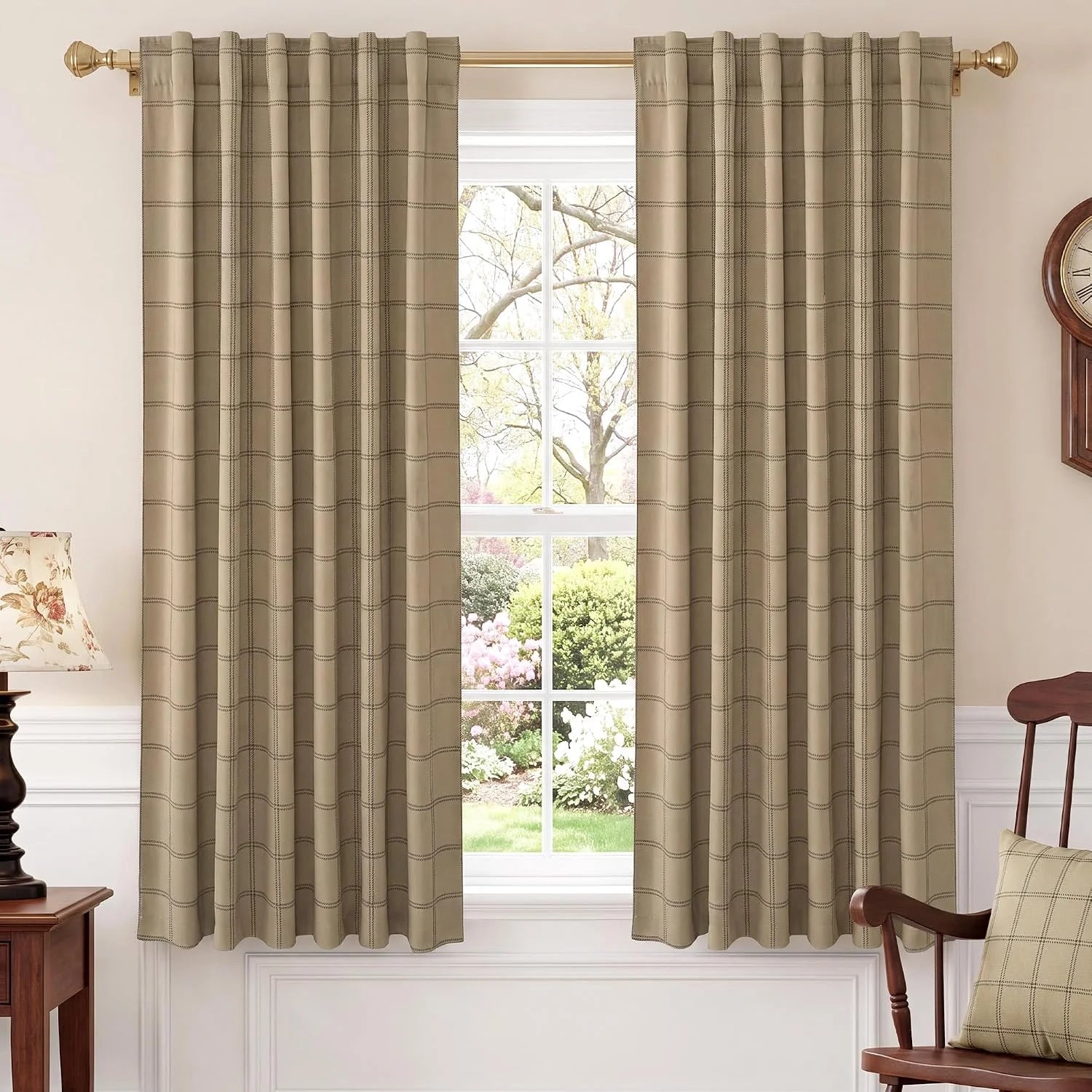 Beige plaid curtains with tailored pleats on a gold rod in a traditional room