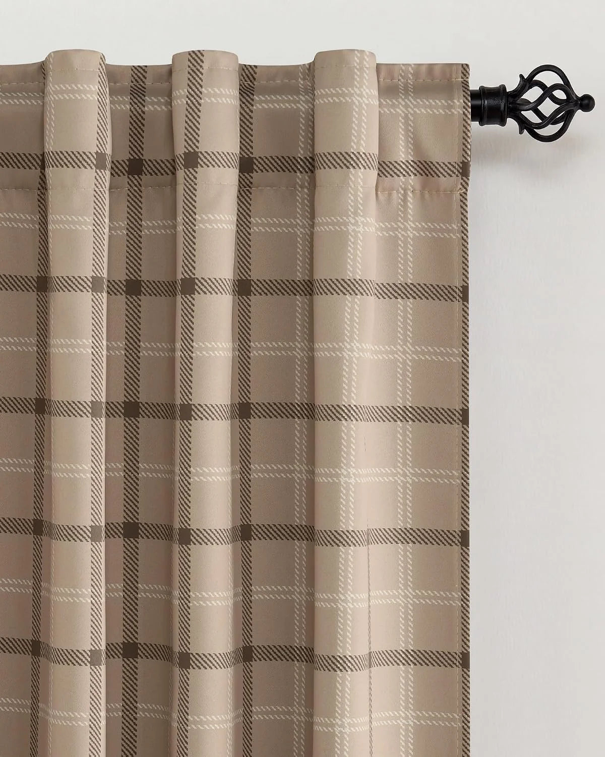 Beige plaid curtain panel with tailored pleats on a black decorative curtain rod