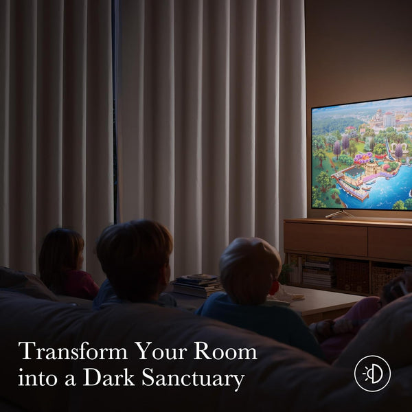 Light beige pleated blackout curtains creating a dark sanctuary for TV watching.