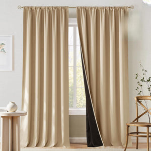 Beige rod pocket blackout curtains hung on a gold rod. The right panel reveals a dark insulating lining.