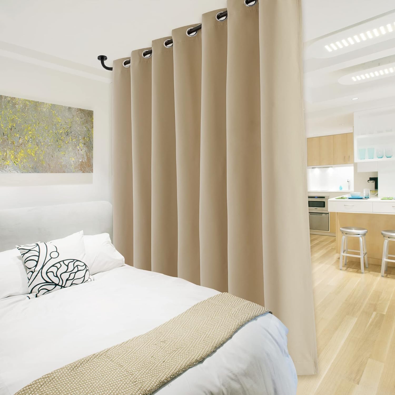 Light beige grommet curtain serving as a room divider between a modern bedroom and kitchen space.