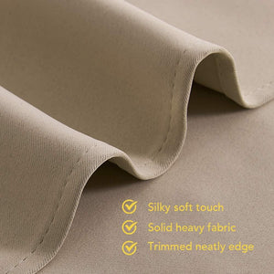 A close-up of a beige, folded fabric, revealing its silky soft texture, solid heavy feel, and a neatly trimmed edge.