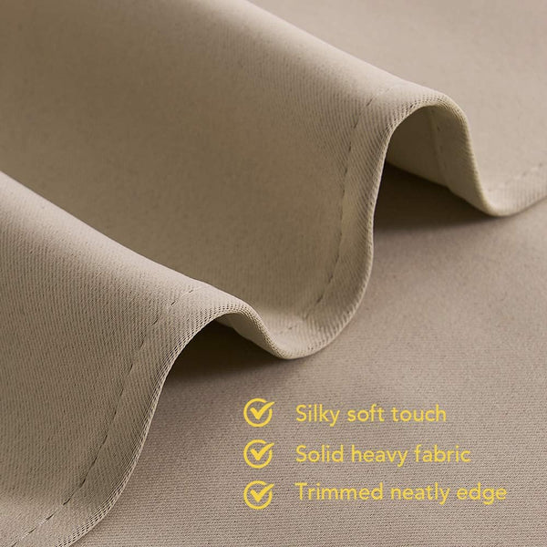 A close-up of a beige, folded fabric, revealing its silky soft texture, solid heavy feel, and a neatly trimmed edge.