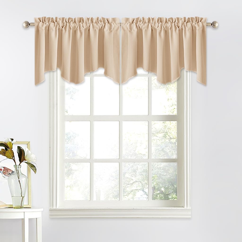 Beige solid fabric gathered scalloped window valance hanging on a silver rod above a white window.