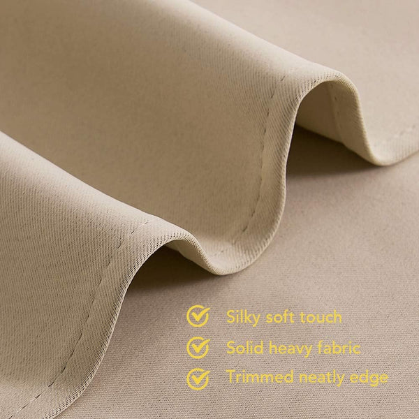 Beige curtain fabric with silky soft touch, heavy solid construction, and neatly trimmed edge.