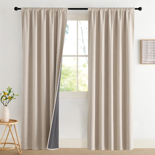 Beige textured rod pocket blackout curtains hung on a black rod, showing dark gray lining.