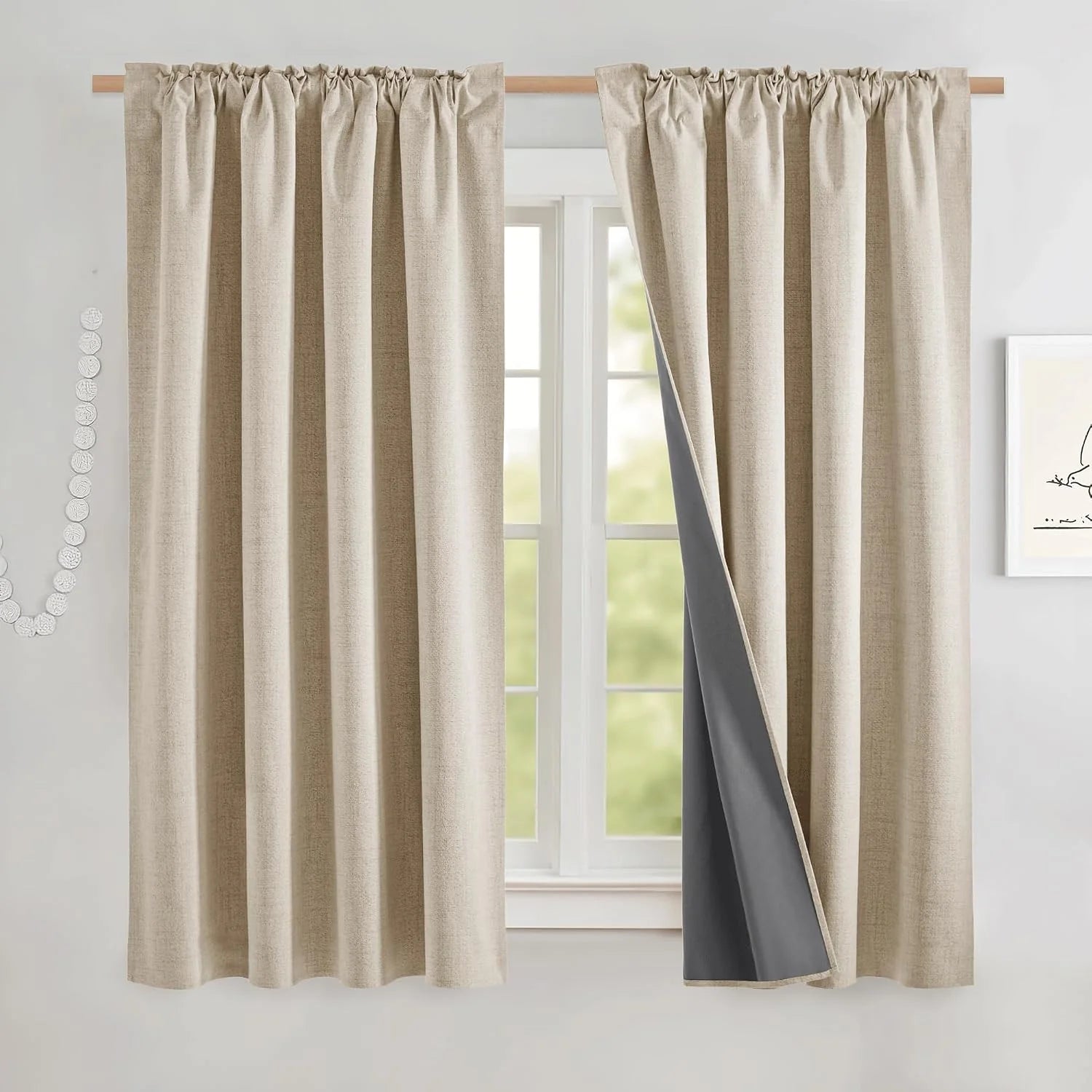 Beige textured blackout curtains with rod pocket top and gray lining on a window