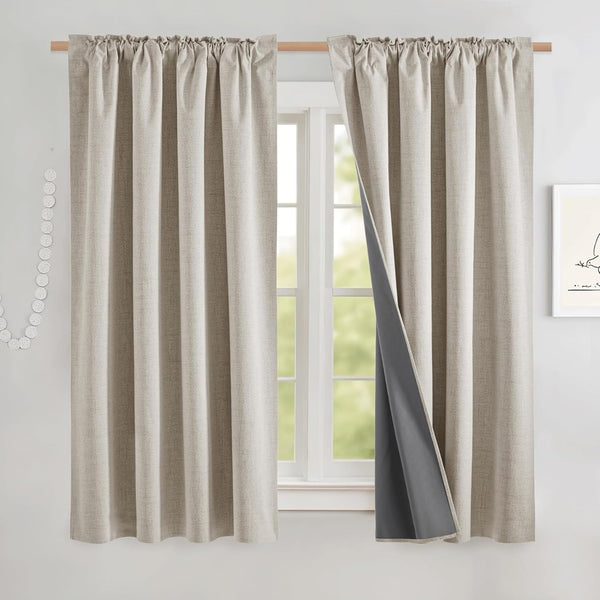 Beige textured blackout curtains with a rod pocket top, showing dark grey lining on a window.