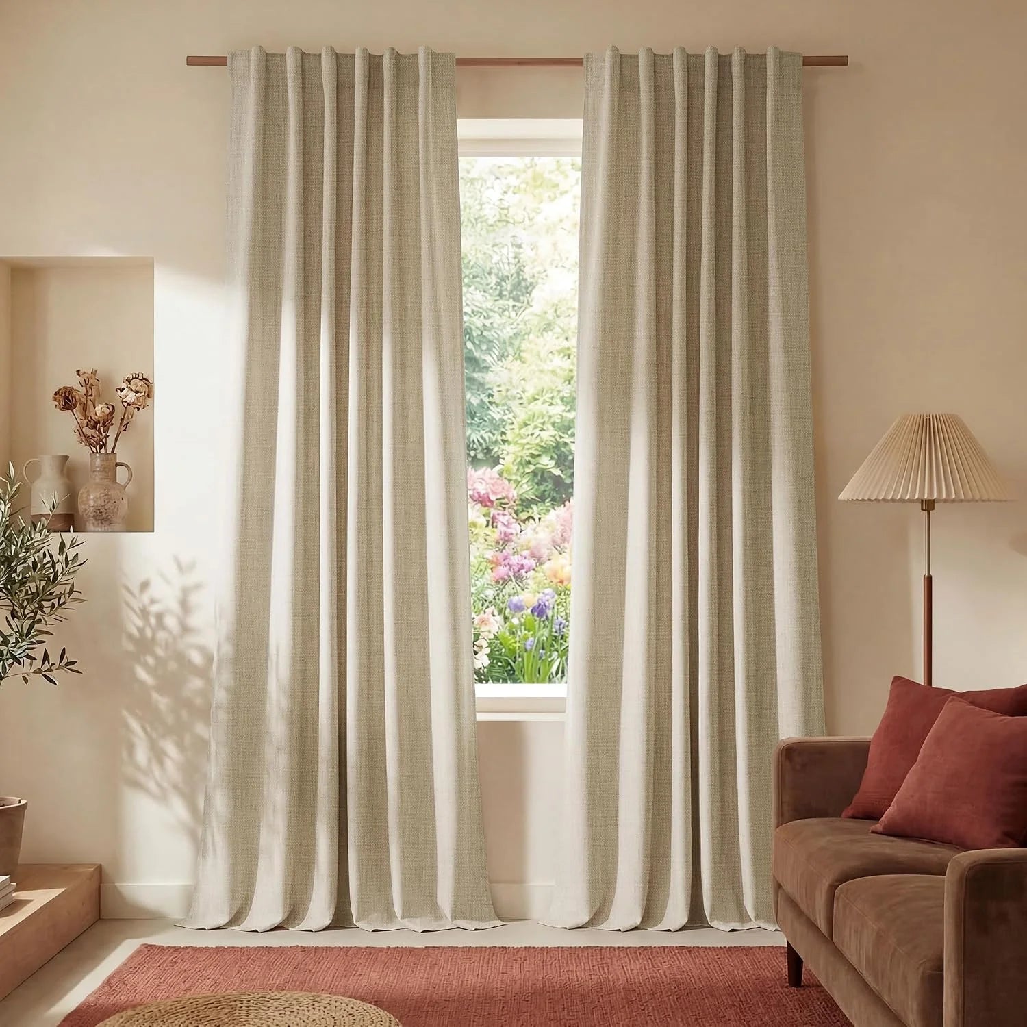 Light beige textured curtains on a wooden rod framing a bright window view in a cozy living room.