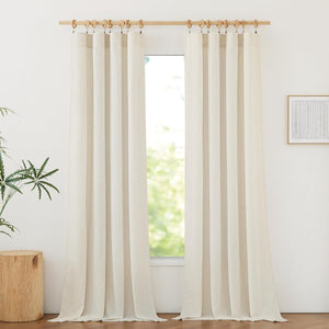 Pair of natural beige linen curtains with visible texture, hanging by clips and wooden rings on a wooden rod.
