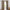Beige textured rod pocket blackout curtains with dark gray lining visible on a wooden rod.