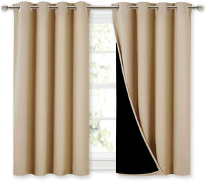 Beige blackout curtains with silver grommet tops. One curtain is open, revealing its black thermal lining.