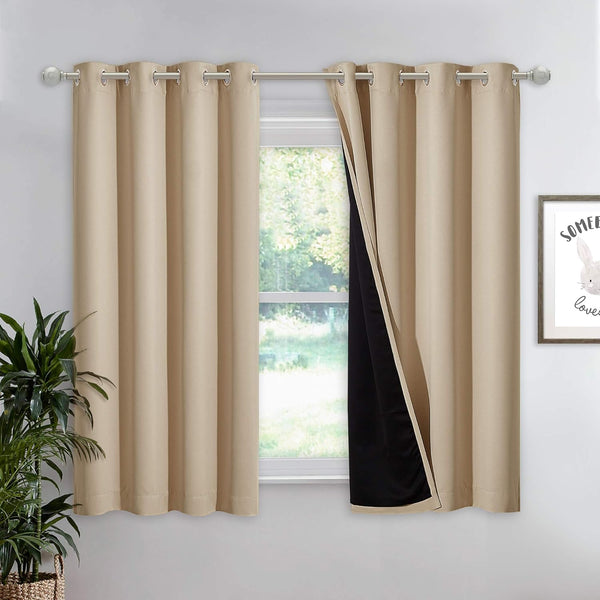 Pair of beige thermal lined grommet curtains partially open on a window, showing black lining.