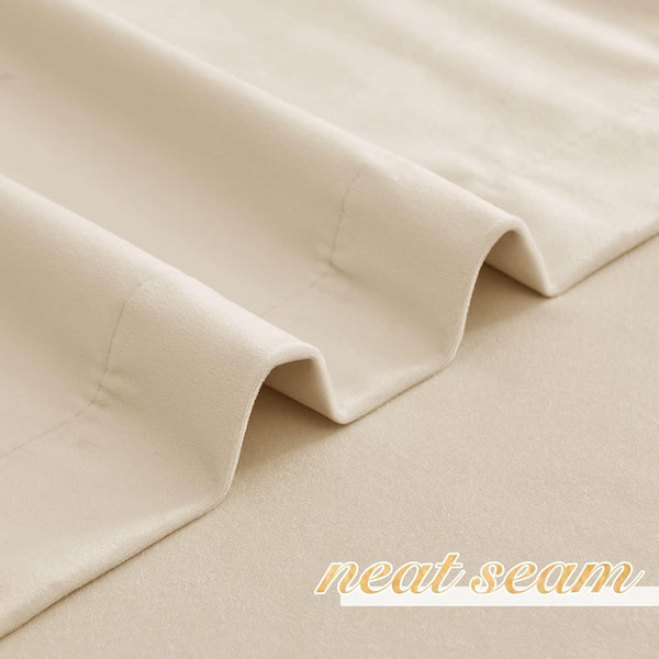 Close-up of a light beige velvet-like curtain fabric showing a neat seam detail.