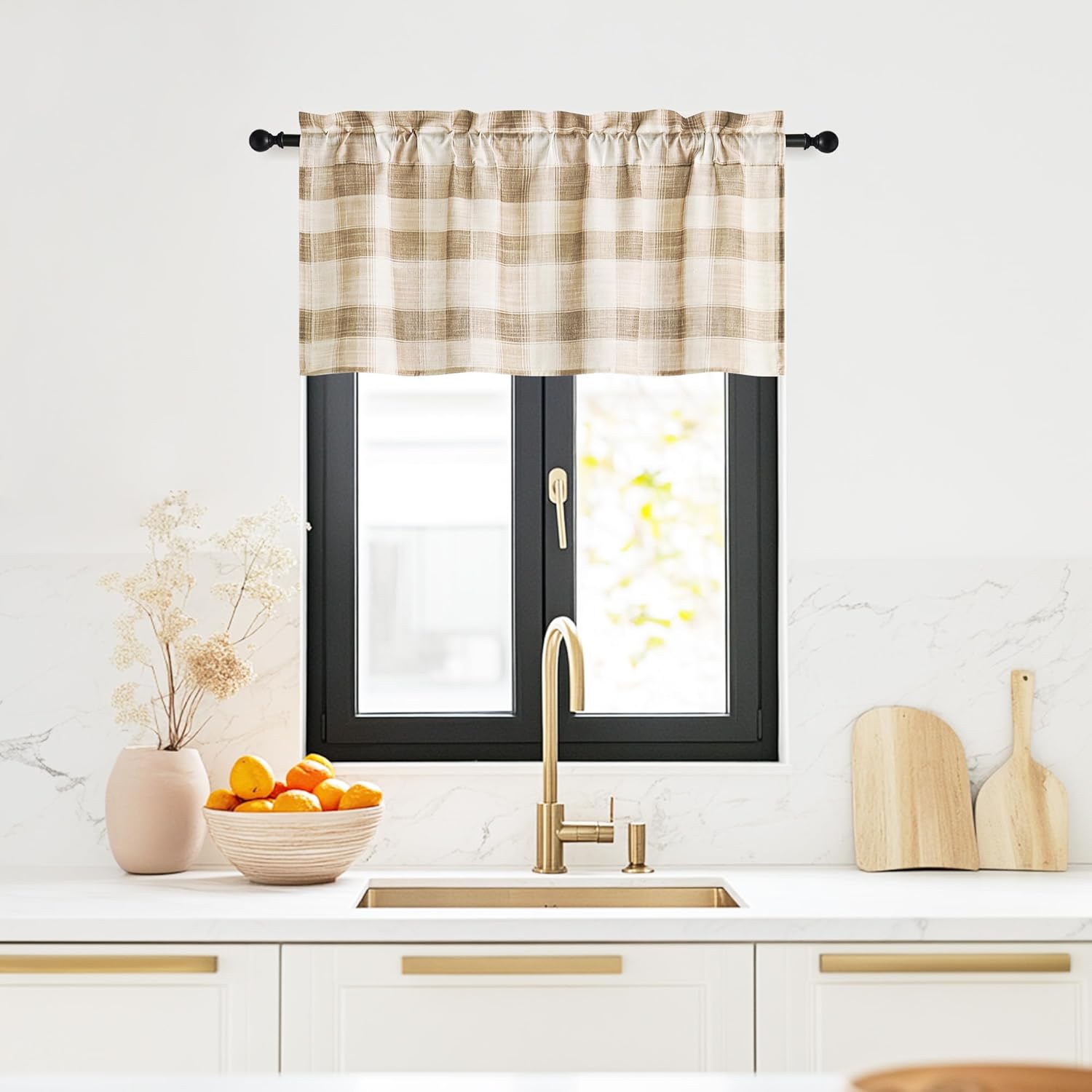 Light beige and white plaid farmhouse valance hung on a black rod above a kitchen sink.