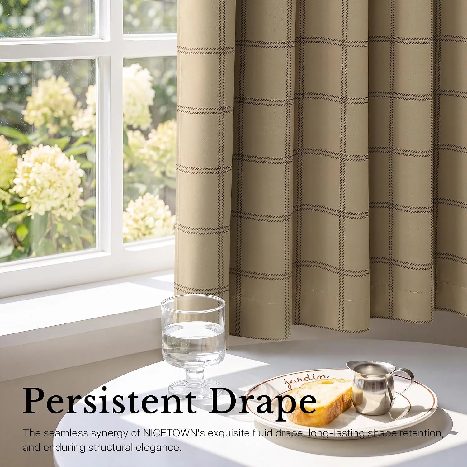 Beige windowpane curtain draped beside a white window in soft natural light