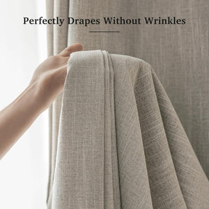 Close-up of a hand holding beige textured woven curtain fabric, highlighting its wrinkle-free drape.