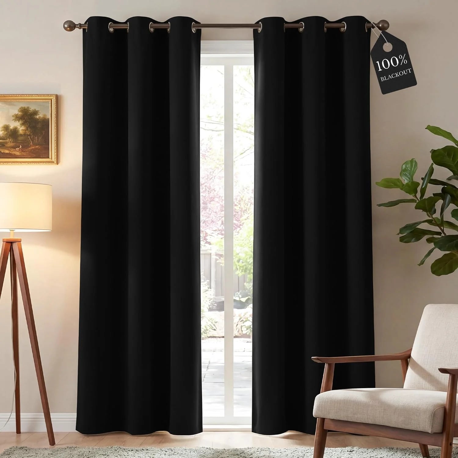 Black blackout curtains with grommet top in a bright living room, modern armchair