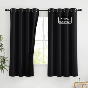 Black 100% blackout curtains with silver grommet tops on a rod. One panel open revealing bright window.
