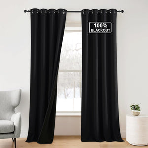 Solid black 100% blackout curtains with grommet top, one panel slightly open, hangs on a window rod.