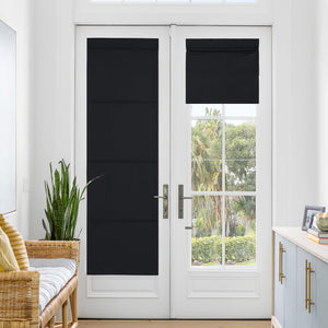 Black blackout flat roman shades on white French doors. One lowered, one partially raised.