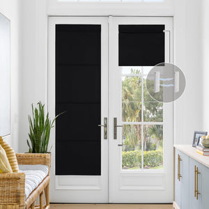 Black cordless magnetic blackout Roman shade on a white French door, showing magnetic hold.