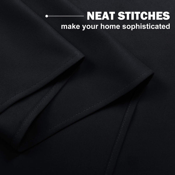 Black curtain fabric with neat, precise stitching visible on the folded hem, showcasing quality craftsmanship.