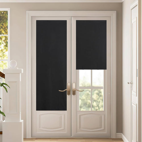 Black blackout roller shades on white French door windows. One closed, one partly open.