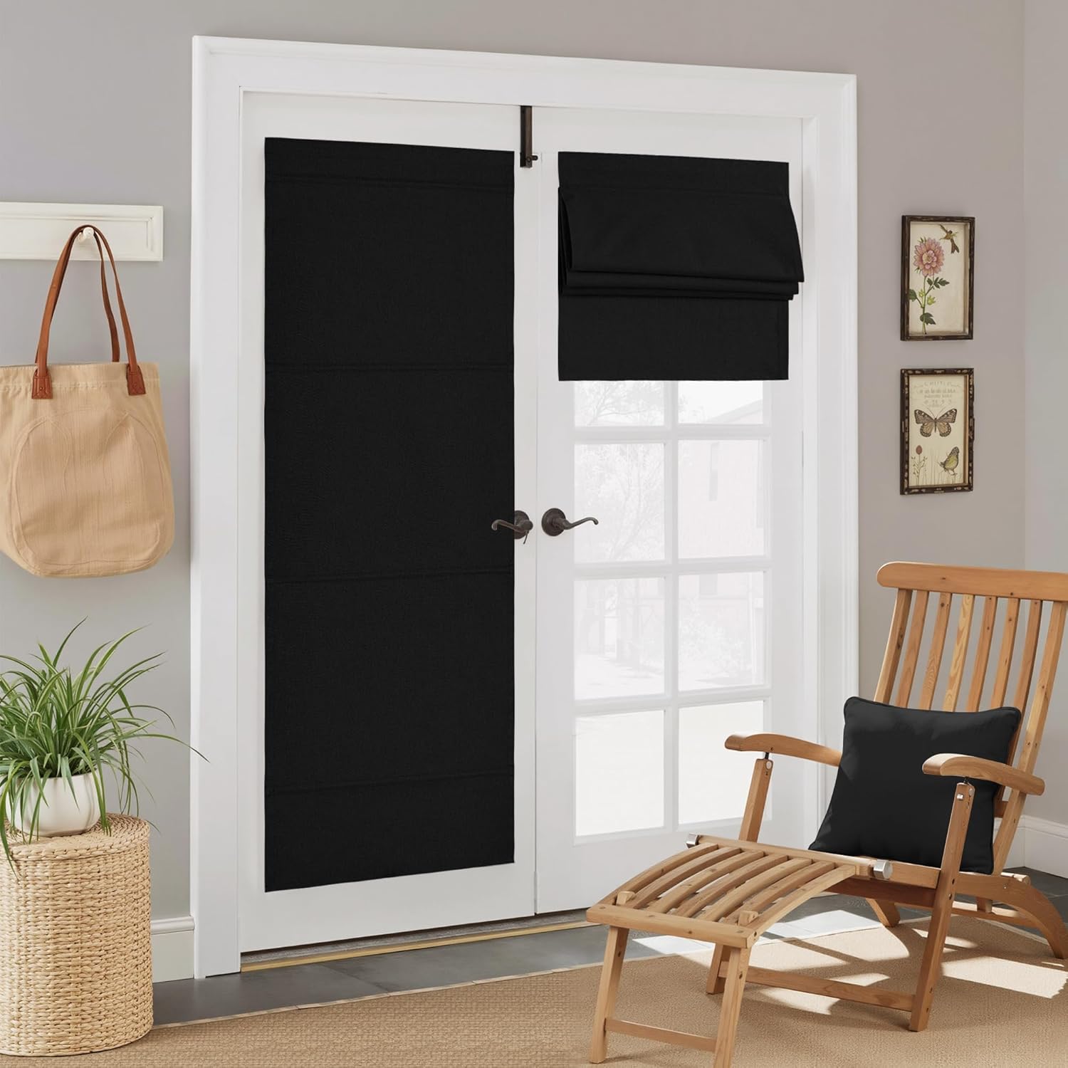Black fabric Roman shades mounted on white French doors, one fully extended, the other partially folded up, offering privacy.