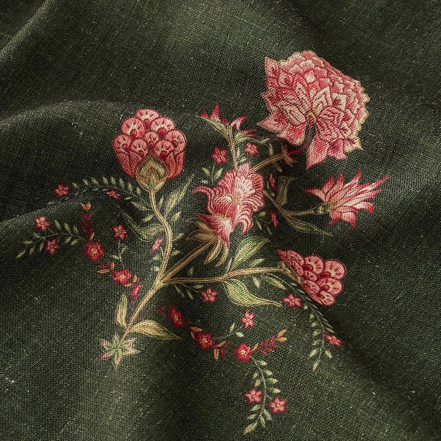 Close-up of black fabric with pink floral embroidery and soft draped texture