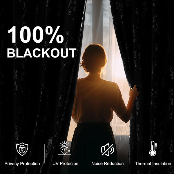 Person pulling back 100% blackout black floral curtains, demonstrating light blocking and thermal insulation.