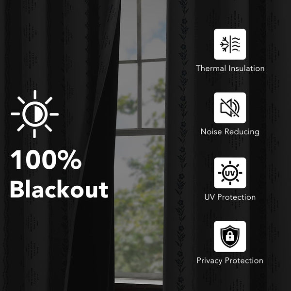 Black blackout curtains with subtle striped texture and decorative floral border by a window.