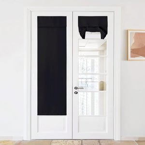 Black blackout fabric panel and a tied-up Roman shade installed on white French doors.