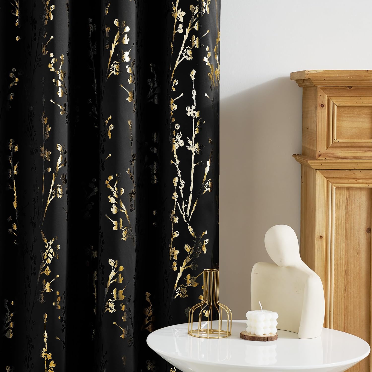 Black fabric curtain with luxurious gold botanical print, featuring delicate branches and blossoms.