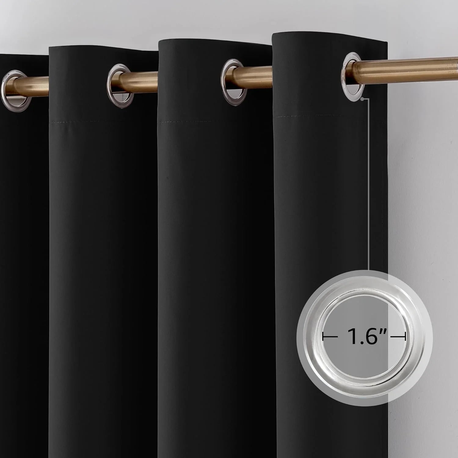 Close-up of black grommet top curtain panel with 1.6-inch silver grommet on gold rod.