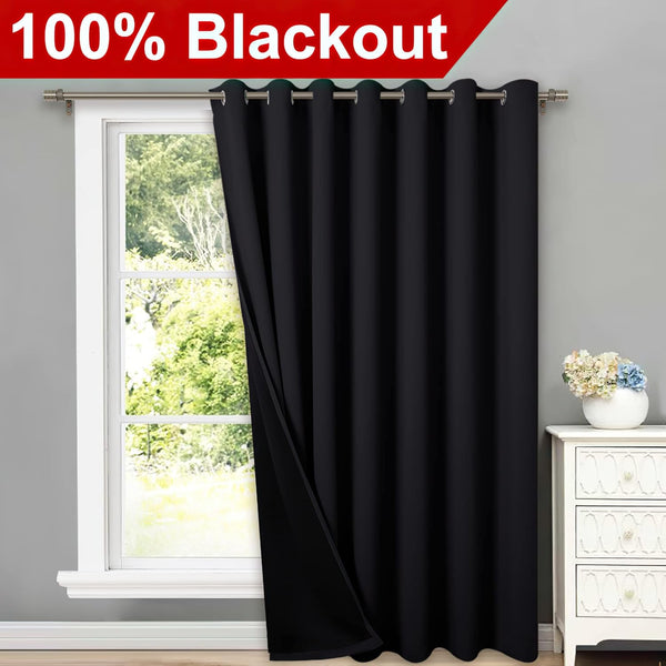 Single black blackout curtain panel with silver grommet top, partially open on a window.