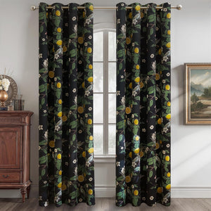 Black grommet-top curtains with a detailed lemon, leaf, and bird botanical print, hanging by a window.