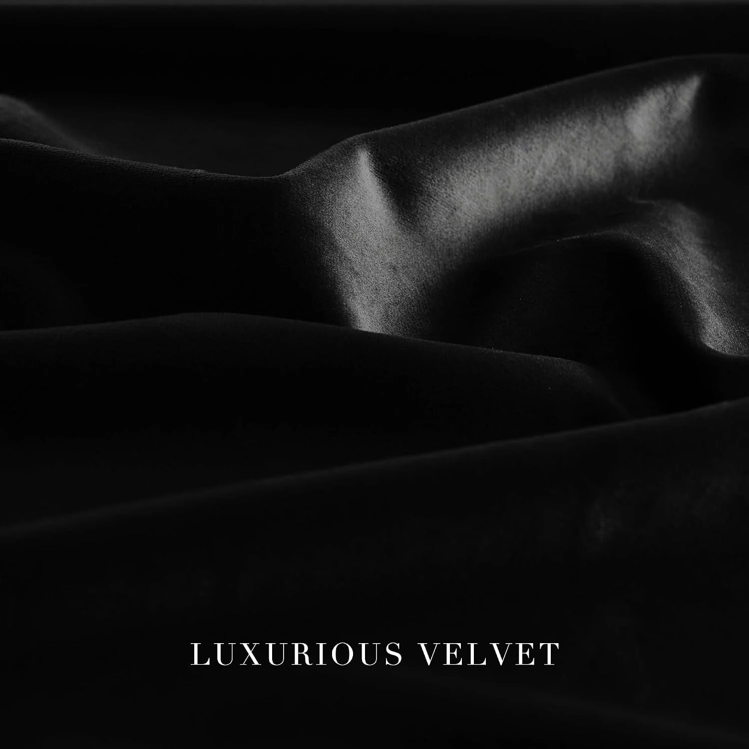 Close-up of black luxurious velvet fabric with soft folds and a smooth sheen