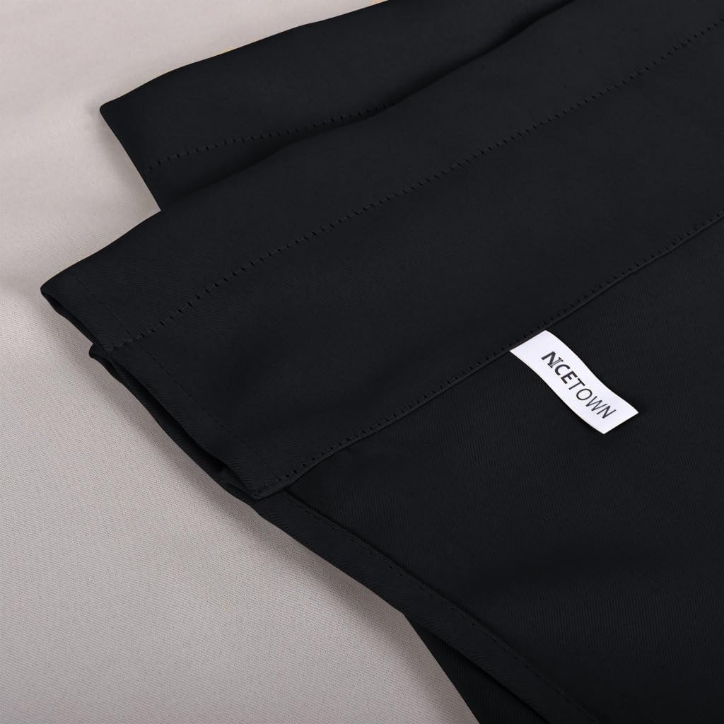 Close-up of black NICETOWN rod pocket blackout curtain showing visible header stitching.
