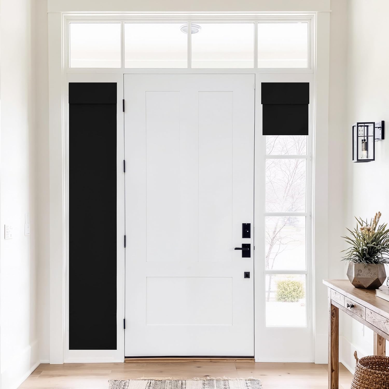 Black privacy shades on sidelight and transom windows of a white front door in a bright entryway.