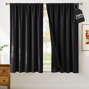 Black rod pocket blackout curtains. One panel open, showing opaque lining and '100% BLACKOUT' tag.