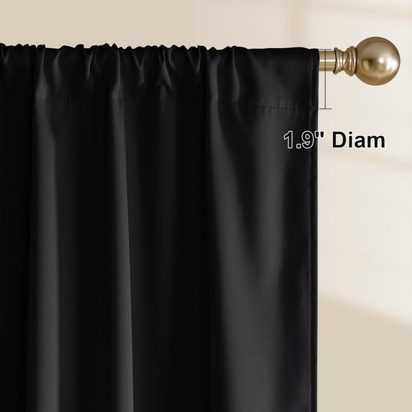 Black rod pocket curtain panel with a gathered top, hanging on a bronze-gold curtain rod.