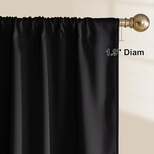 Black fabric curtain panel with rod pocket top hanging on a gold curtain rod, highlighting 1.9 inch diameter.