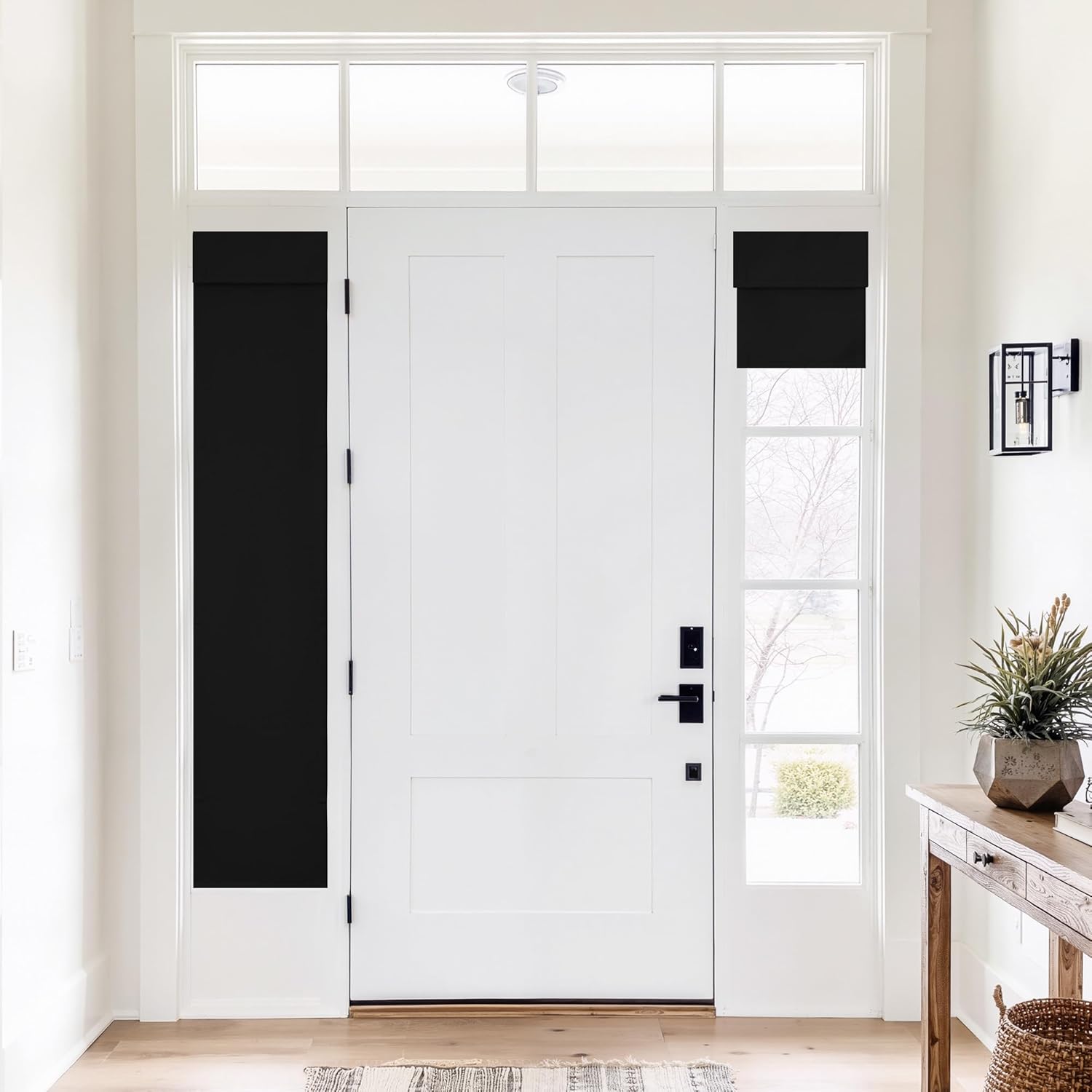 Modern black Roman blackout shades on sidelight windows next to a white entry door.