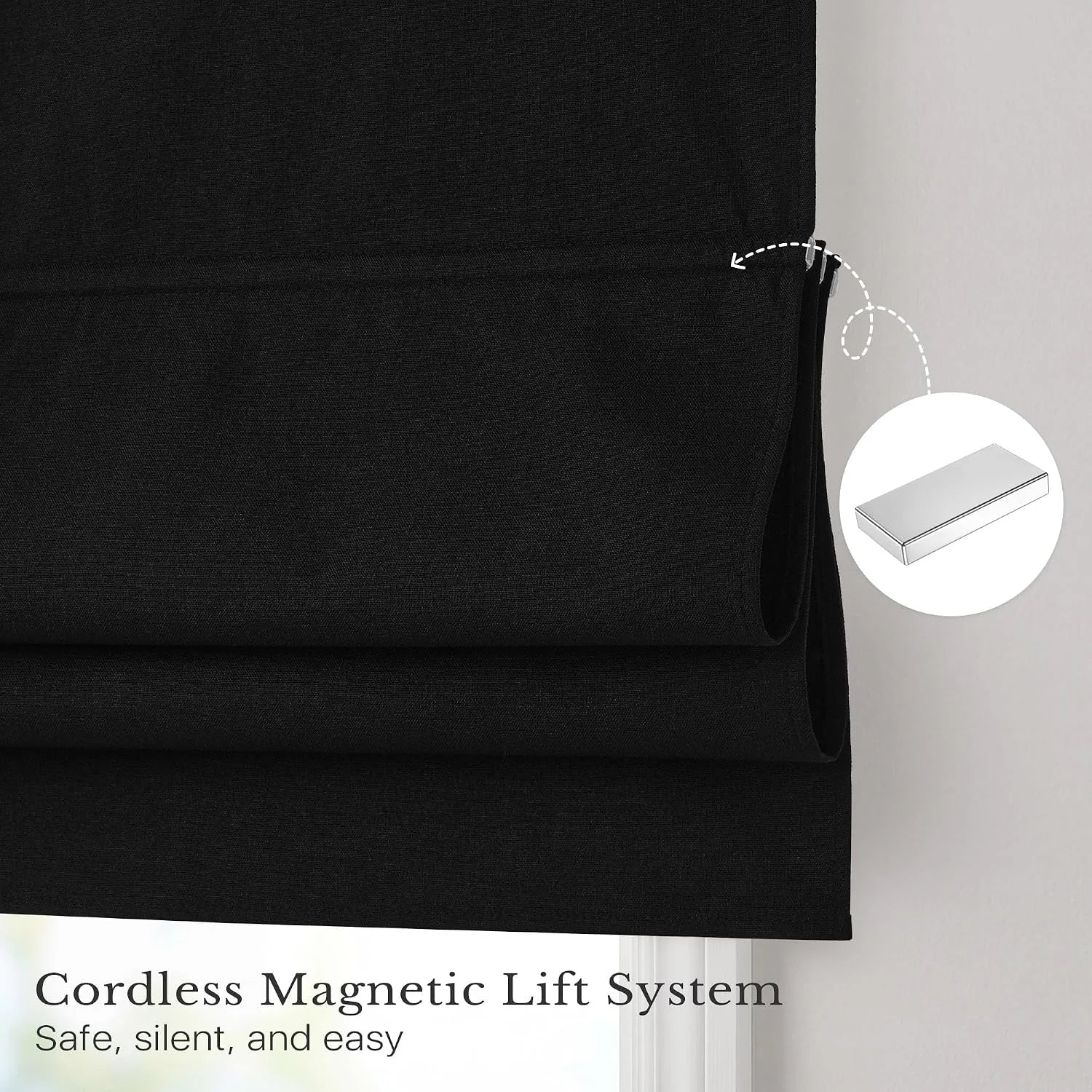 Black Roman shade with a detailed view of its cordless magnetic lift system.