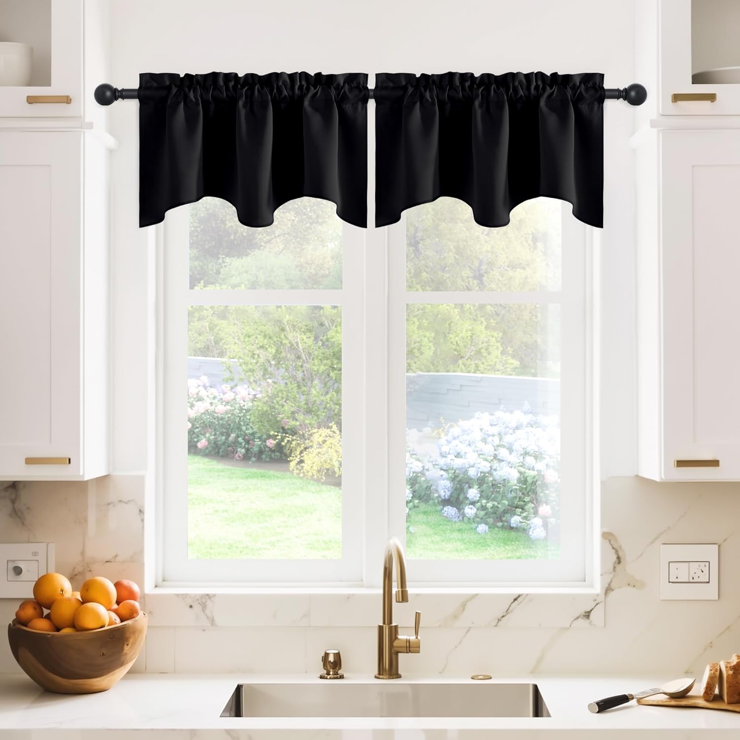 Black fabric valance with ruffled rod pocket and scalloped bottom, over kitchen window.