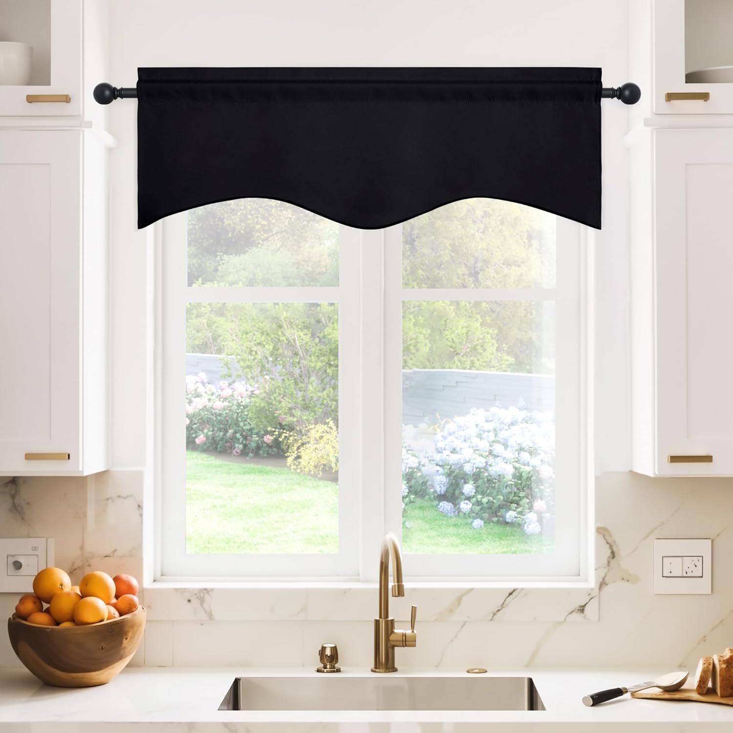 Black scalloped window valance with a rod pocket header hangs over a bright kitchen window.